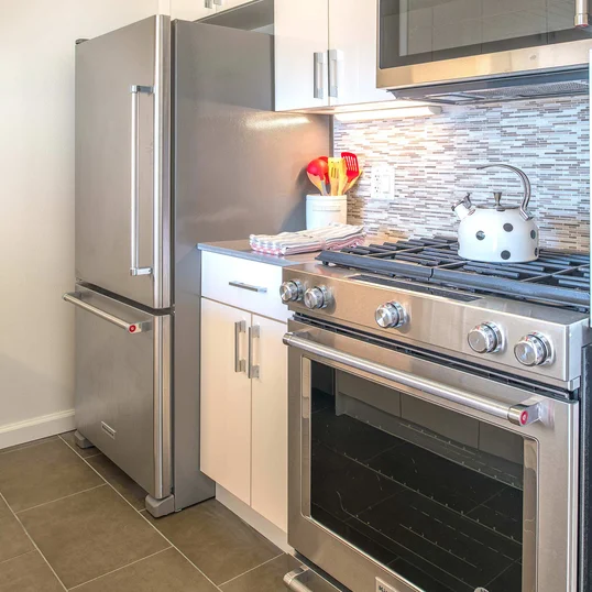 The gourmet kitchen at One Union Square South features Euro-style cabinetry and granite countertops.